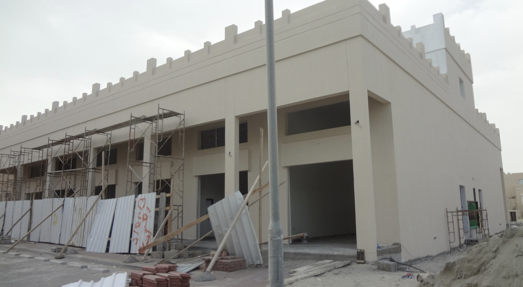 Community retail development — colonnade and crenellated parapet
