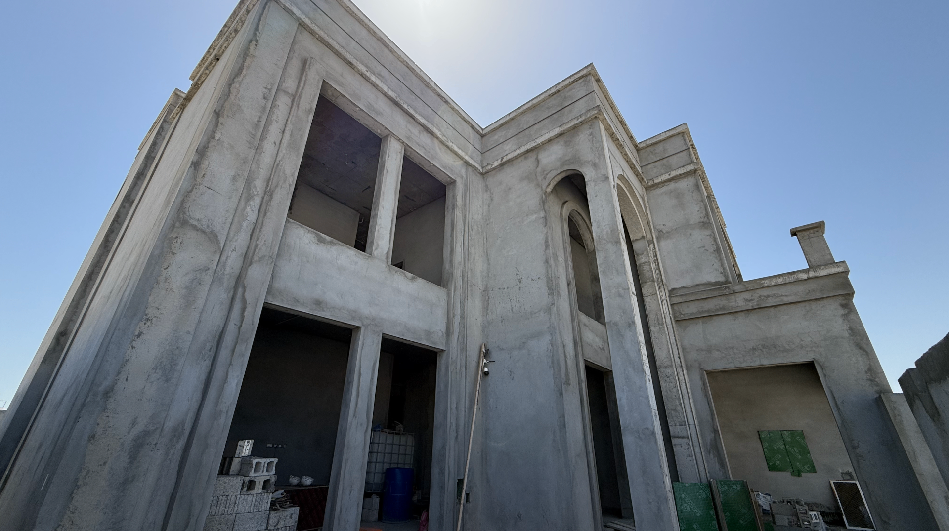 Riffa Albuhair Villa construction — Corner view · double-height façade